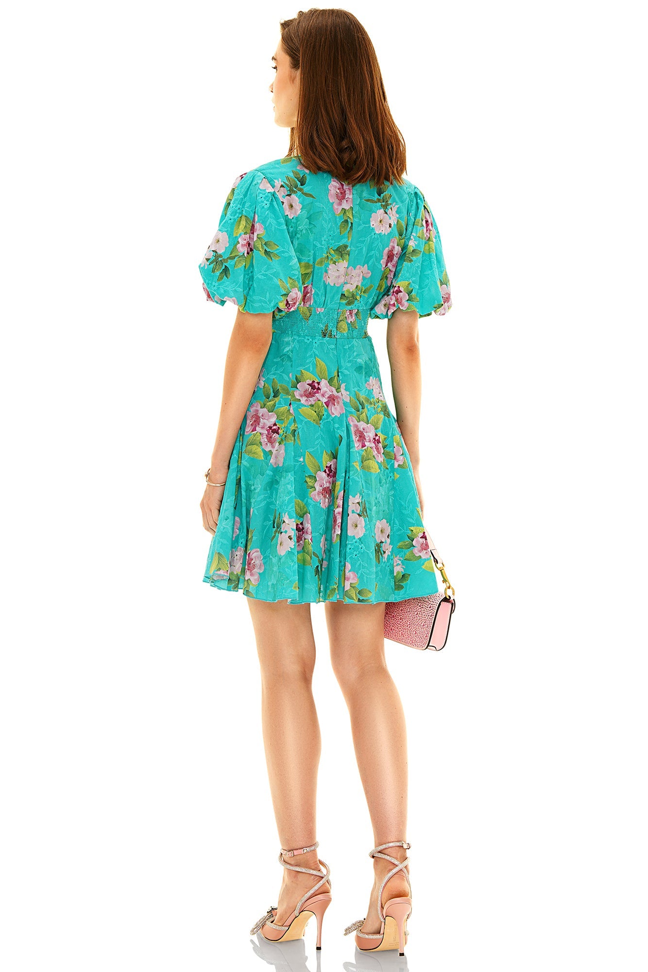 Back view of a Pretty Pixie women's floral dress in turquoise with short puff sleeves